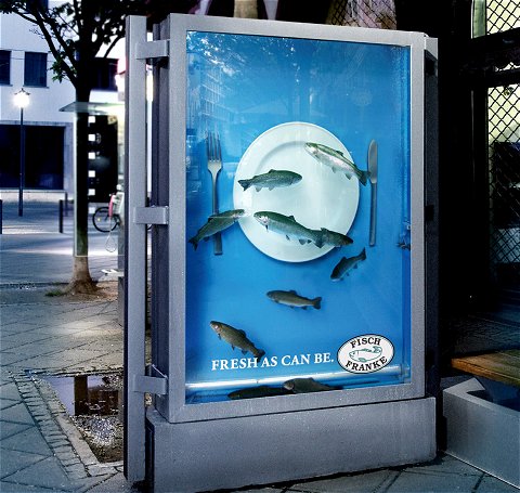 屋外広告で魚料理の新鮮さをアピール。